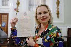 Teacher Gra holding her Cambridge CELTA certificate
